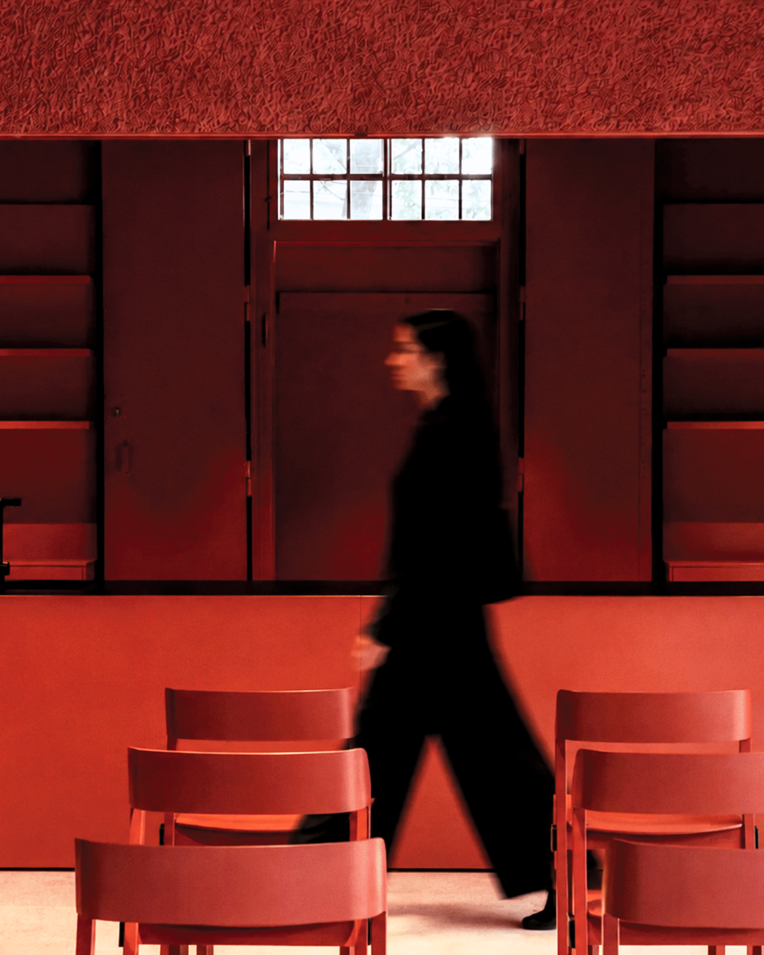 Person walking through a red interior